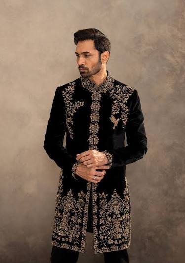 Luxury black embroidered sherwani for men with intricate royal detailing, perfect for weddings and receptions.